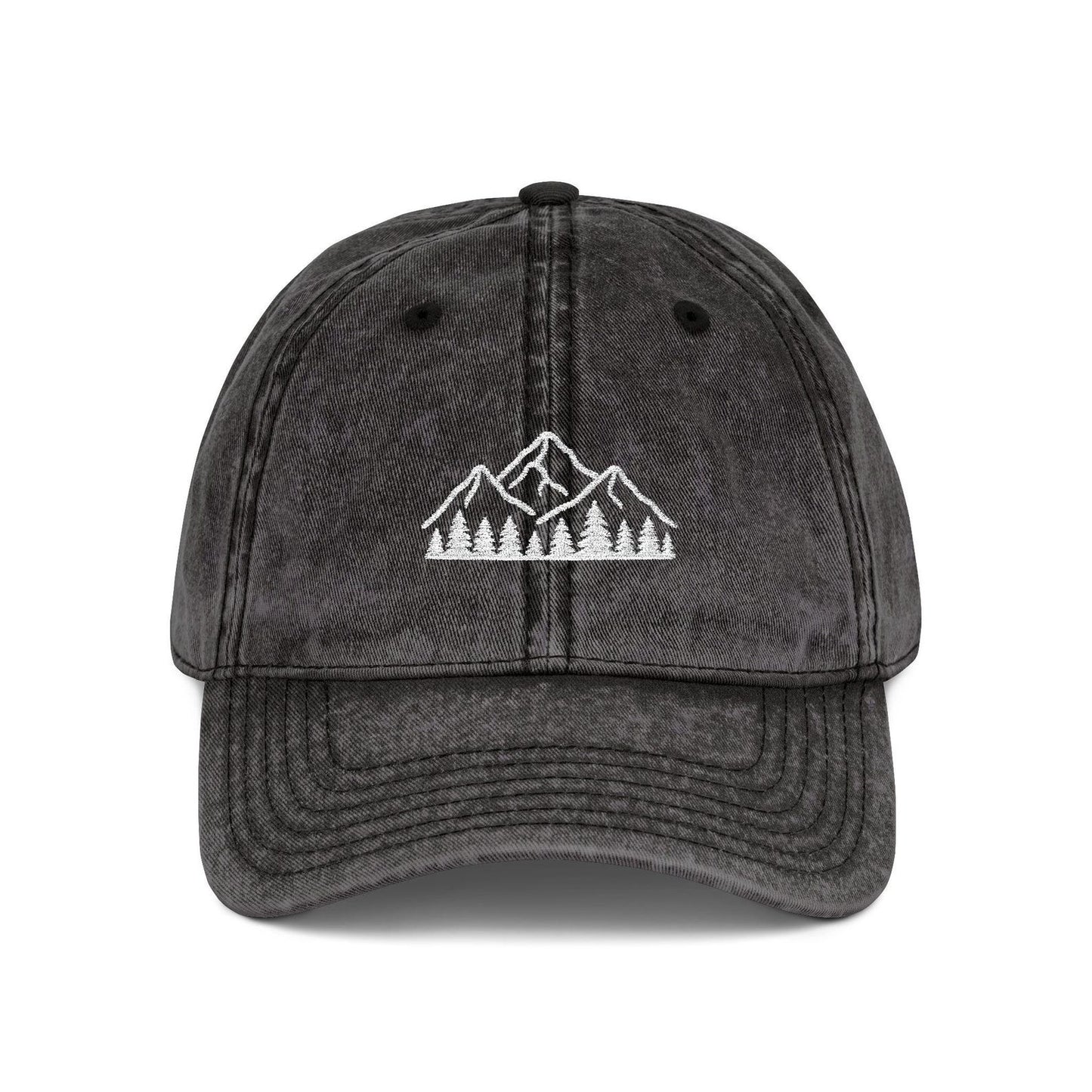 Black washed dad hat embroidered with white mountain and forest design