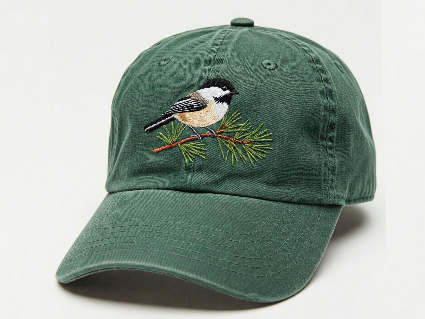 Forest green dad hat with embroidered black-capped chickadee perched on pine branch – perfect for birdwatchers and outdoor lovers