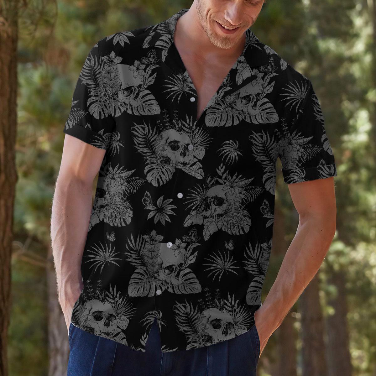 Model styling the skull and tropical leaf Hawaiian shirt with casual pants
