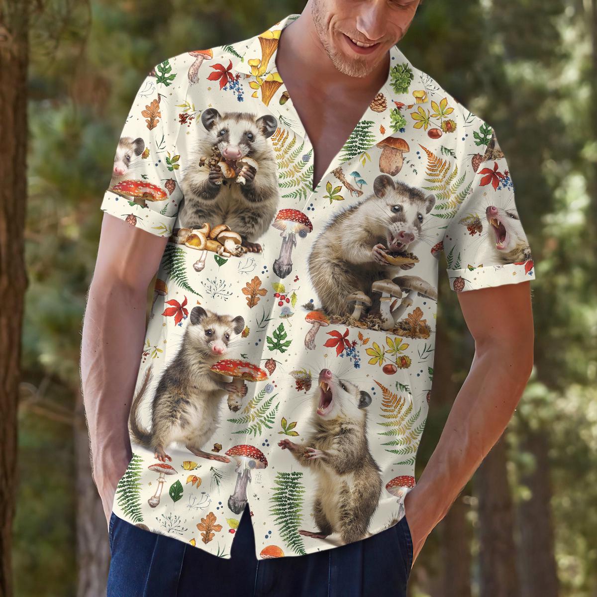 Model outdoors wearing the printed Hawaiian shirt featuring opossums and forest botanicals