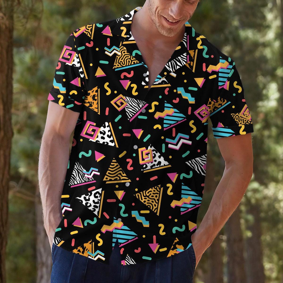 Model styling the black patterned Hawaiian shirt outdoors