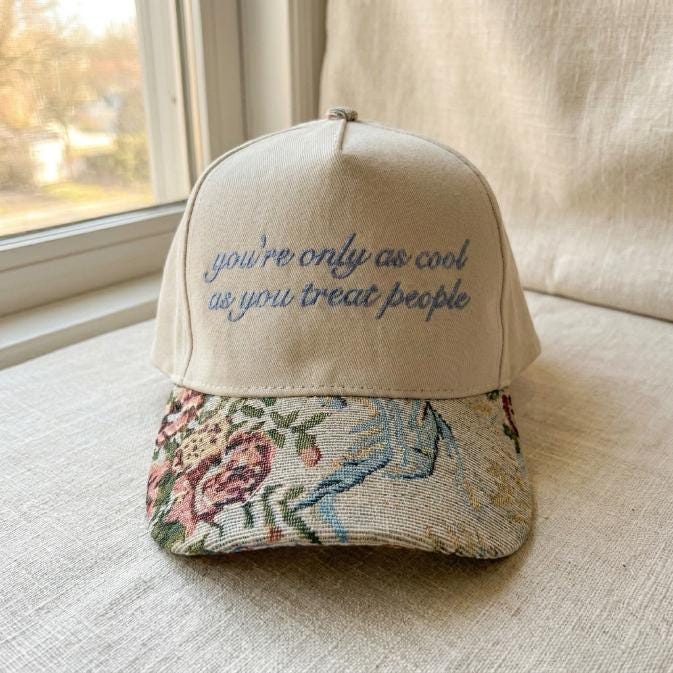 Front view of embroidered quote baseball cap with colorful floral brim