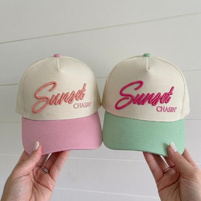 Two pastel two-tone trucker caps with raised Sunset Chasin' embroidery