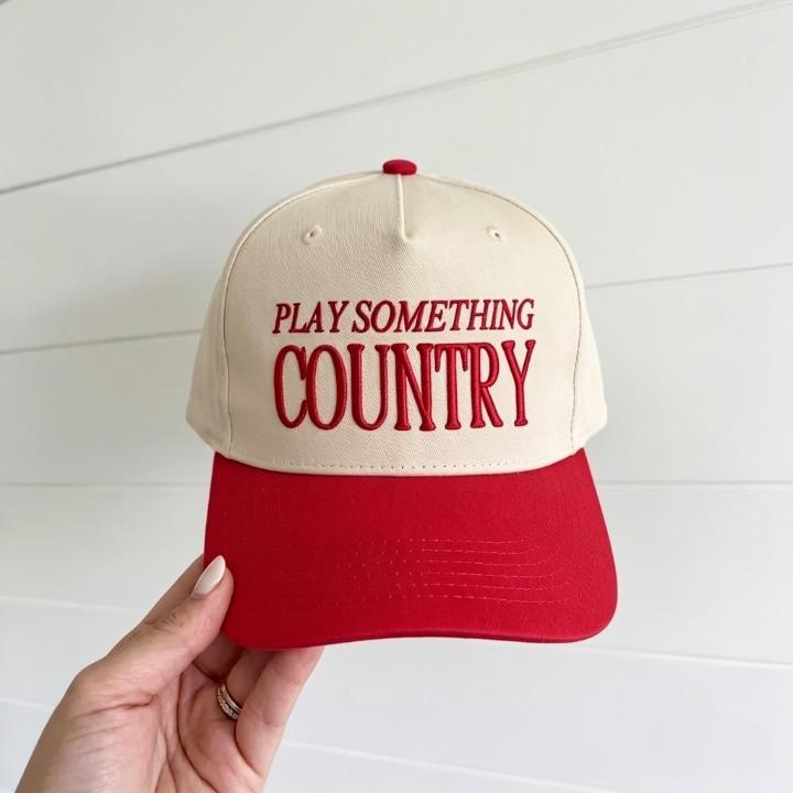 Two-tone country trucker hat with red brim and Play Something Country embroidery