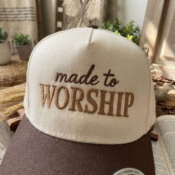Front view of a made to worship embroidered trucker cap