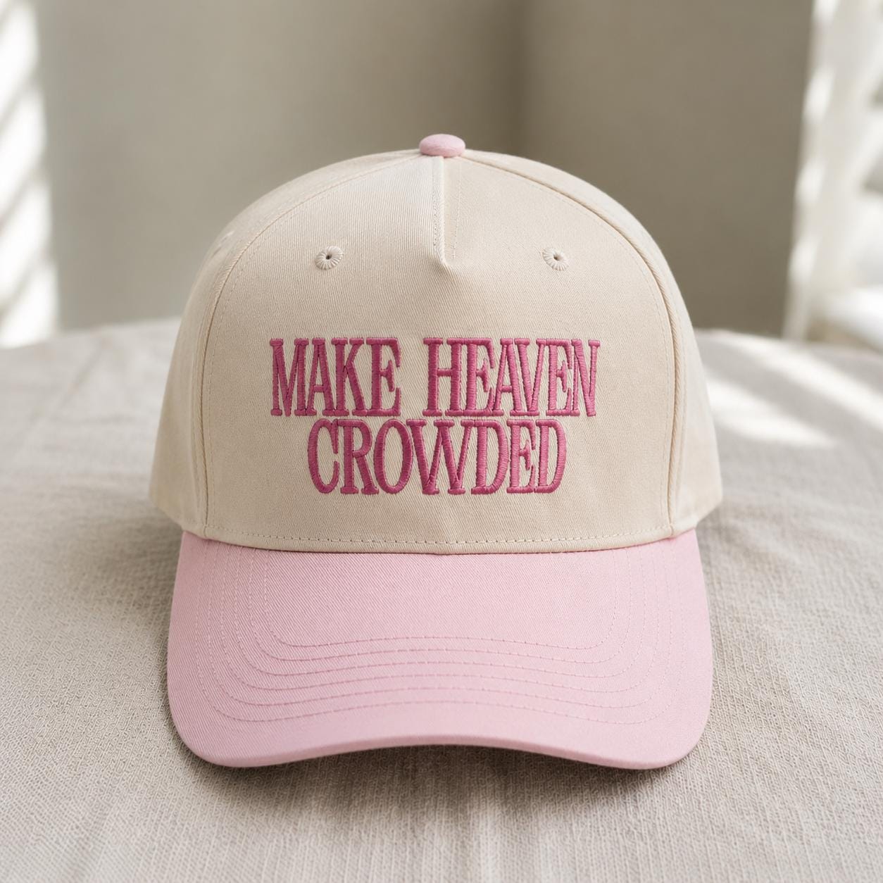 Front view of embroidered Make Heaven Crowded two-tone trucker hat