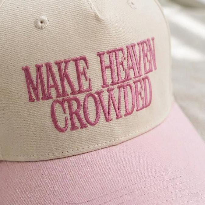 Close-up of pink embroidery on a cream and pink trucker hat