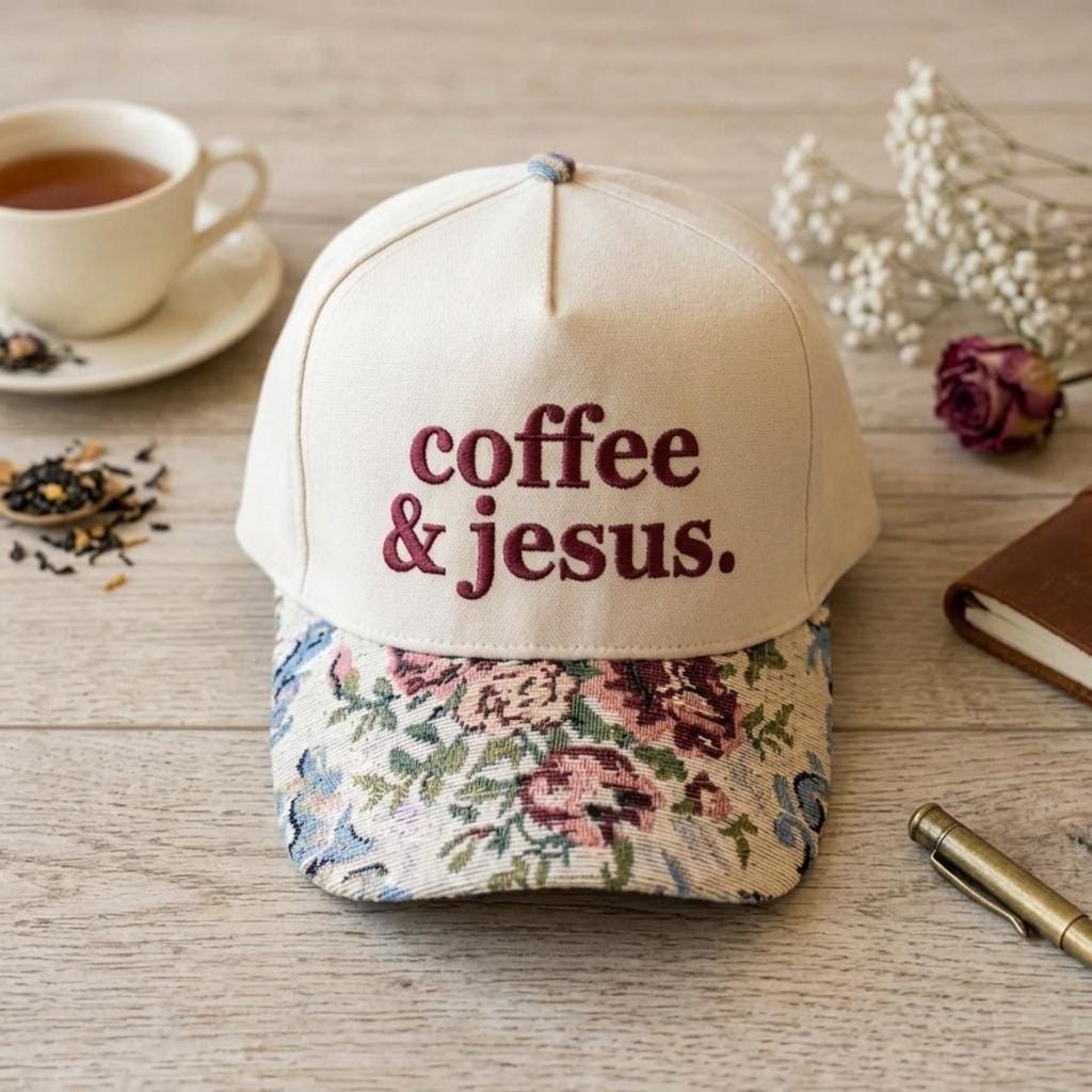 Front view of a cream embroidered coffee and Jesus hat with floral brim