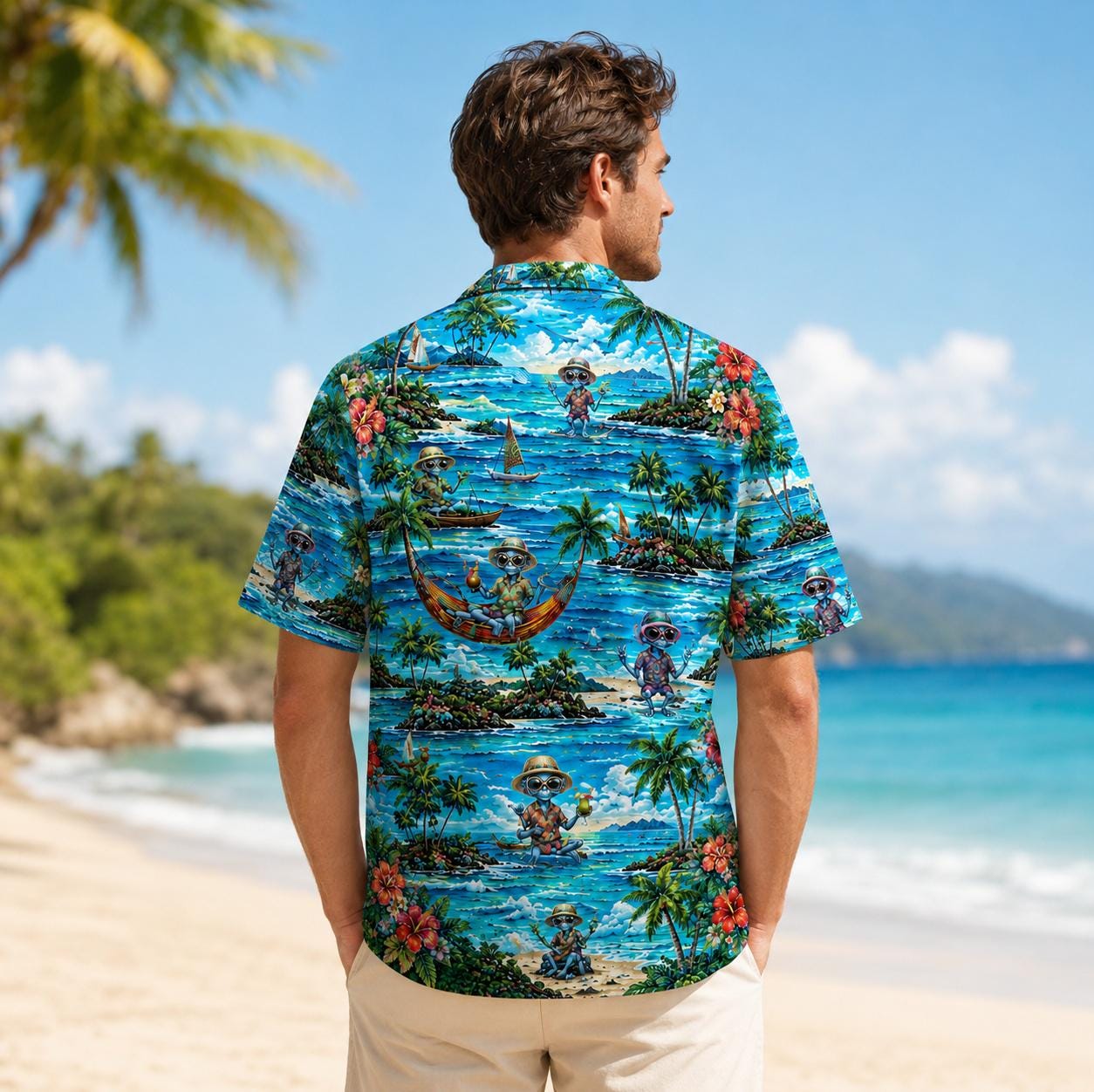 Back view of a man wearing a bright Hawaiian shirt with tropical ocean and island artwork