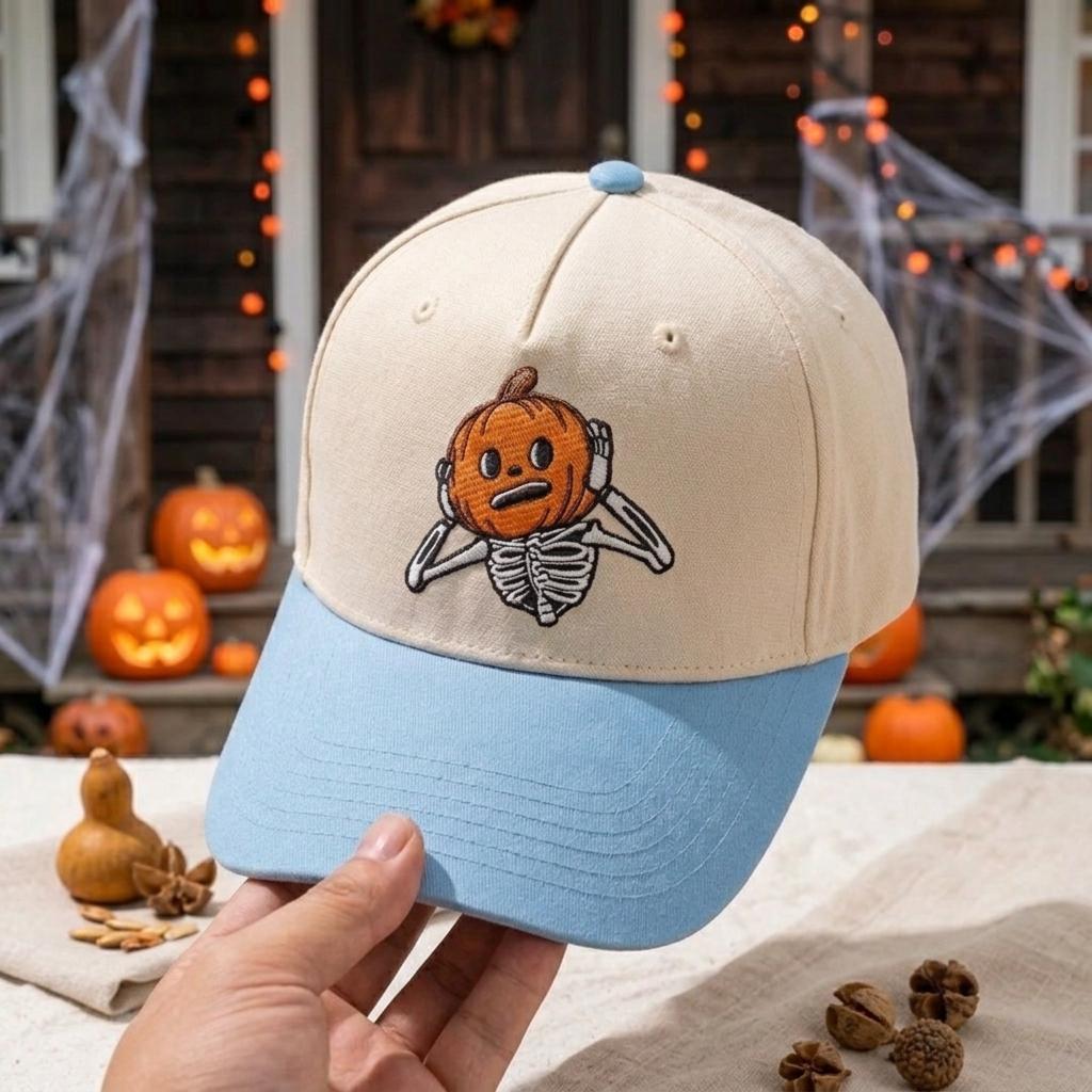 Two-tone pumpkin skeleton cap shown at an angle with cream crown and blue brim