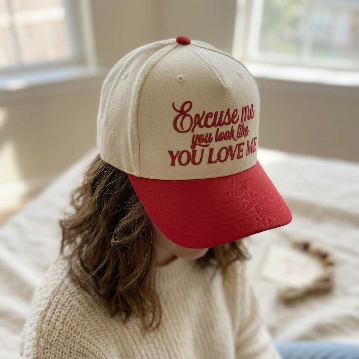 Side view of embroidered two-tone trucker cap worn with a casual outfit