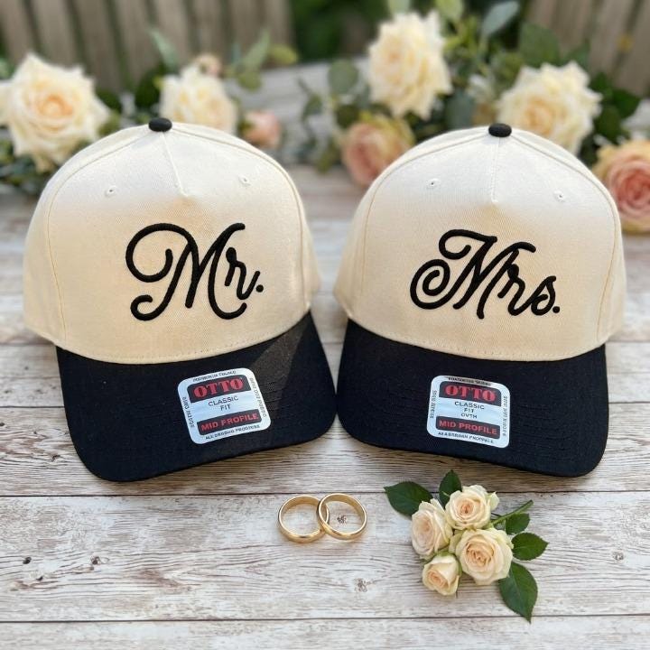 Mr. and Mrs. couple hats styled with wedding rings and roses