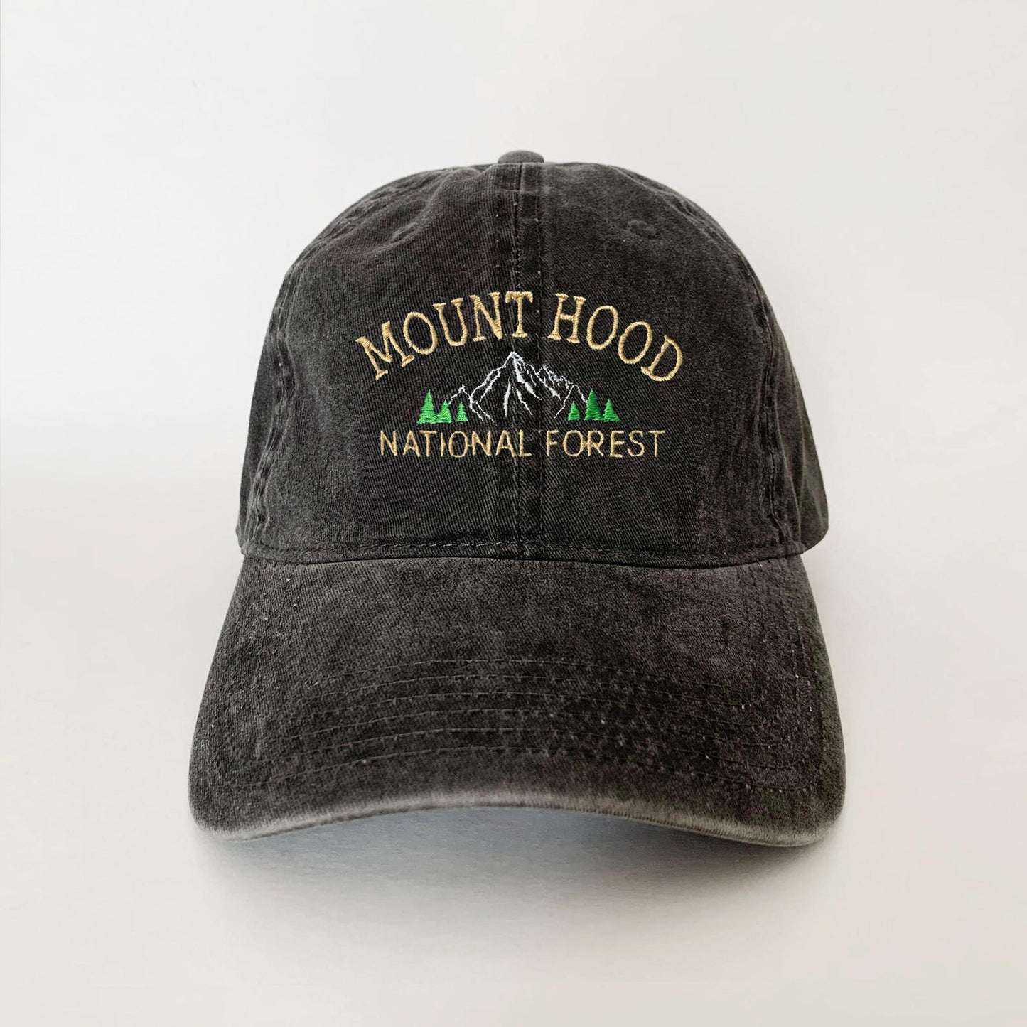 Washed black dad hat with embroidered Mount Hood mountain and pine trees – perfect for national forest lovers and hikers