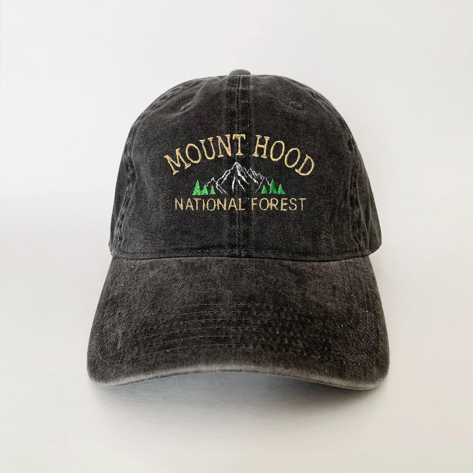 Washed black dad hat with embroidered Mount Hood mountain and pine trees – perfect for national forest lovers and hikers