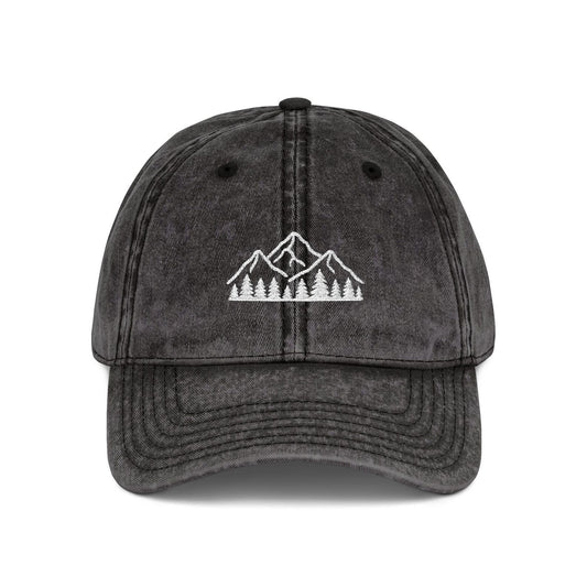 Black washed dad hat embroidered with white mountain and forest design