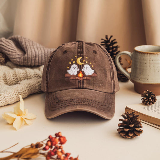 Brown washed dad hat with embroidered ghosts by a campfire under moon and stars – cozy fall Halloween design