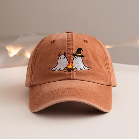 Burnt orange dad hat with embroidered devil and witch ghosts roasting marshmallows by a fire – cute Halloween fall accessory