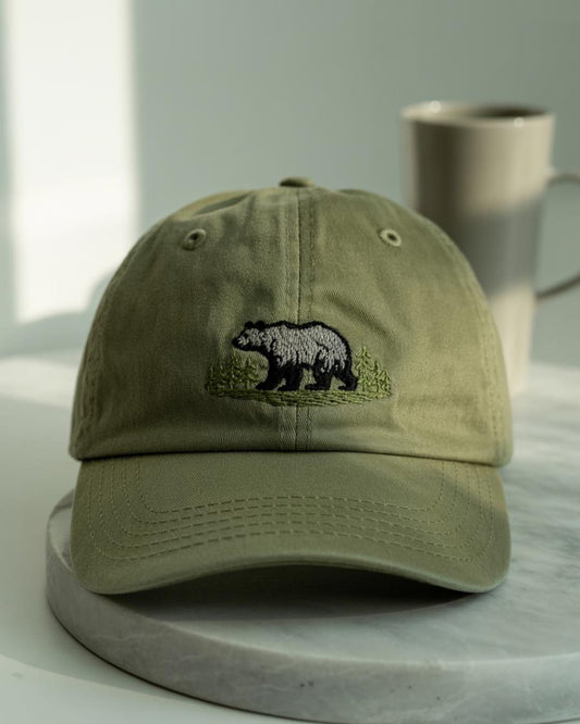 Olive green washed dad cap with embroidered bear and pine forest – perfect for hikers, nature lovers, and outdoor adventures
