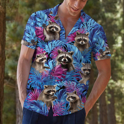 Man outdoors wearing a blue raccoon print vacation shirt