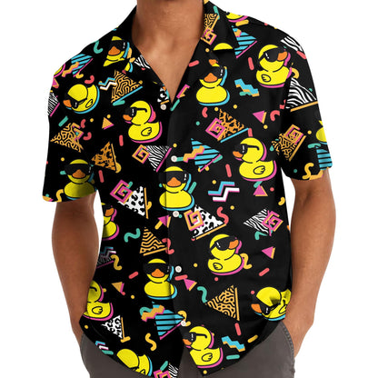 Person wearing a black rubber duck Hawaiian shirt with sunglasses ducks and bright retro graphics