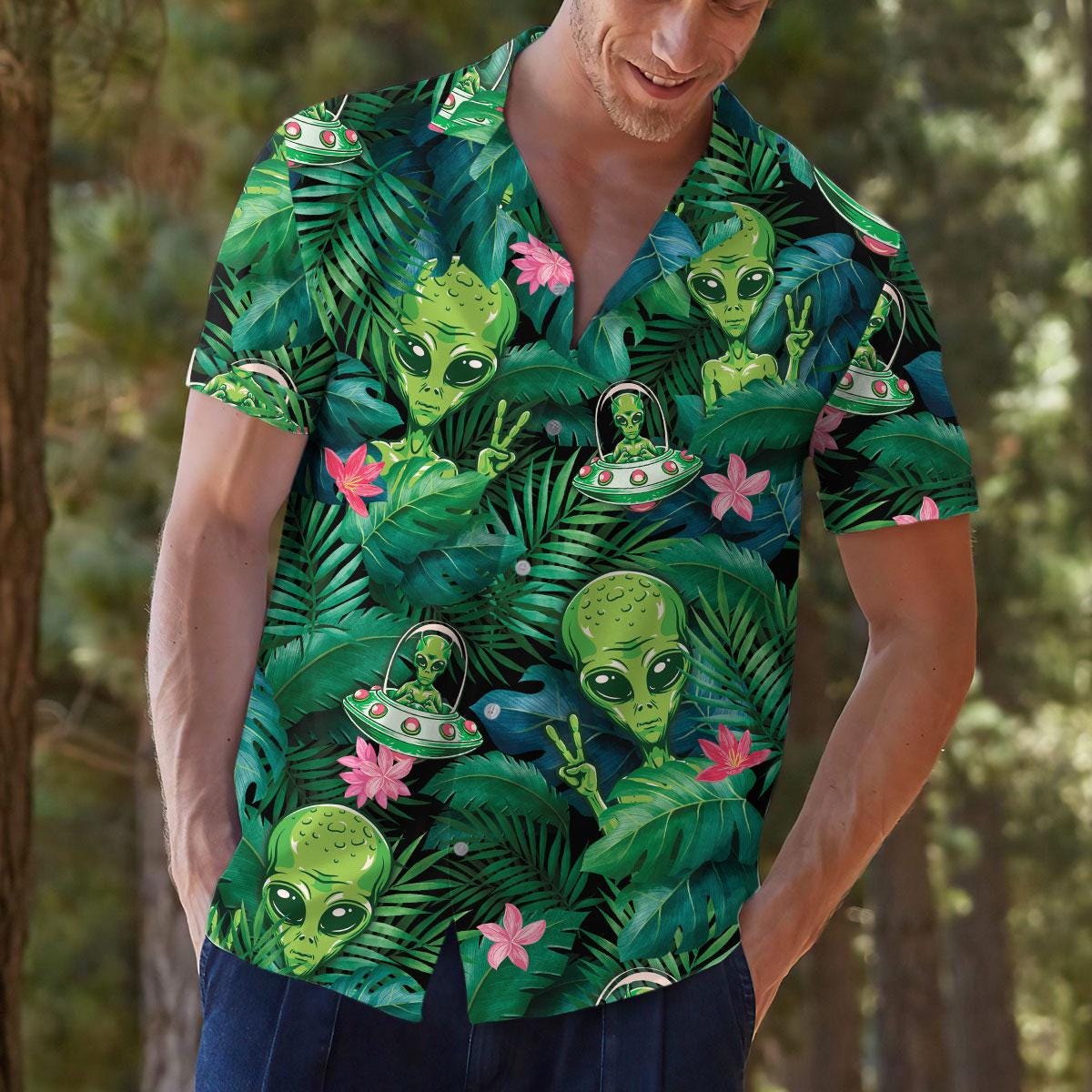 Person modeling alien tropical Hawaiian shirt outdoors with jungle and flower design