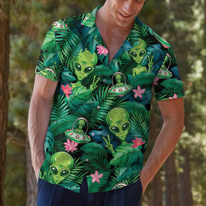 Person modeling alien tropical Hawaiian shirt outdoors with jungle and flower design