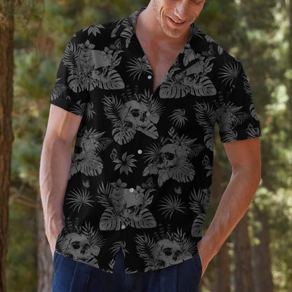 Model styling the skull and tropical leaf Hawaiian shirt with casual pants