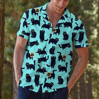 Model styling the aqua cat-print Hawaiian shirt with dark pants