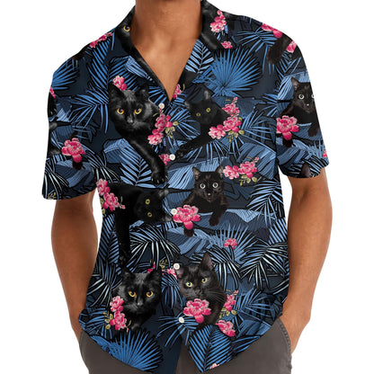 Model wearing black cat Hawaiian shirt with blue tropical leaf pattern