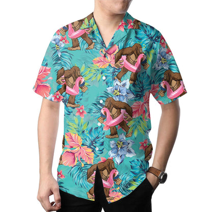 Model wearing the turquoise ape and pink flamingo Hawaiian shirt with tropical flowers