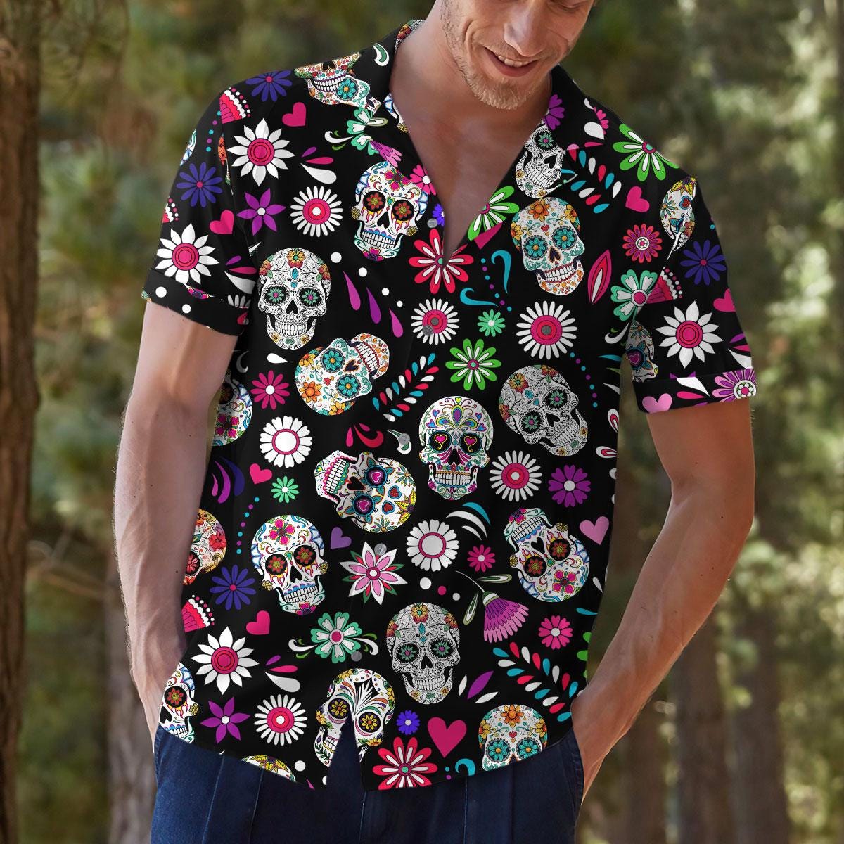 Model wearing a vibrant floral sugar skull Hawaiian shirt with jeans
