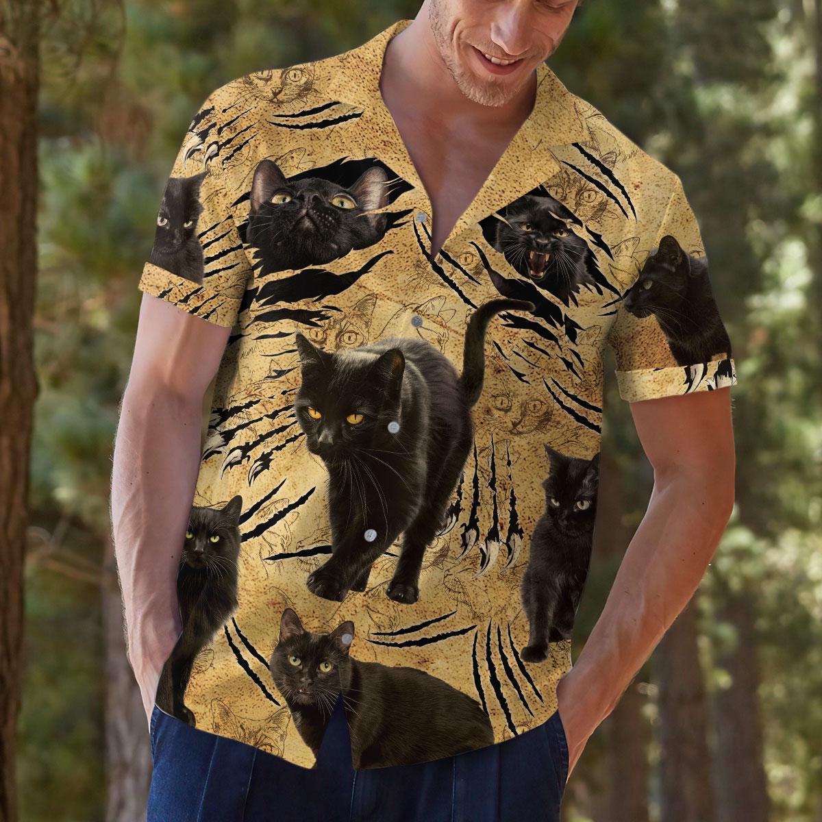 Lifestyle view of a man wearing a bold black cat Hawaiian shirt outdoors