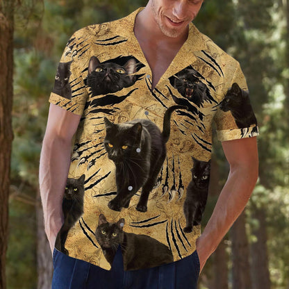 Lifestyle view of a man wearing a bold black cat Hawaiian shirt outdoors