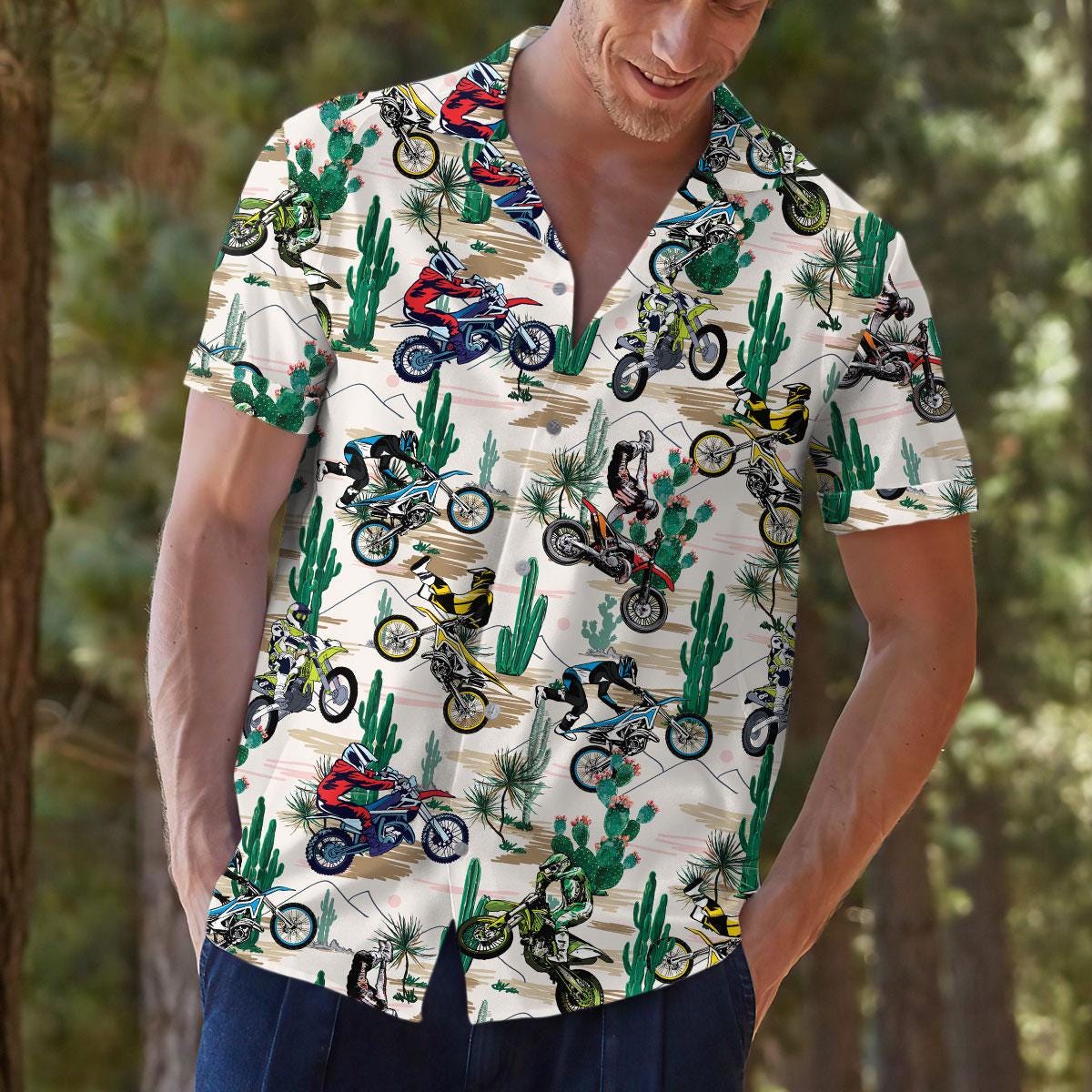 Model outdoors wearing a patterned motocross Hawaiian shirt with desert cactus print