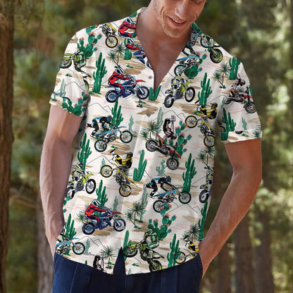 Model outdoors wearing a patterned motocross Hawaiian shirt with desert cactus print
