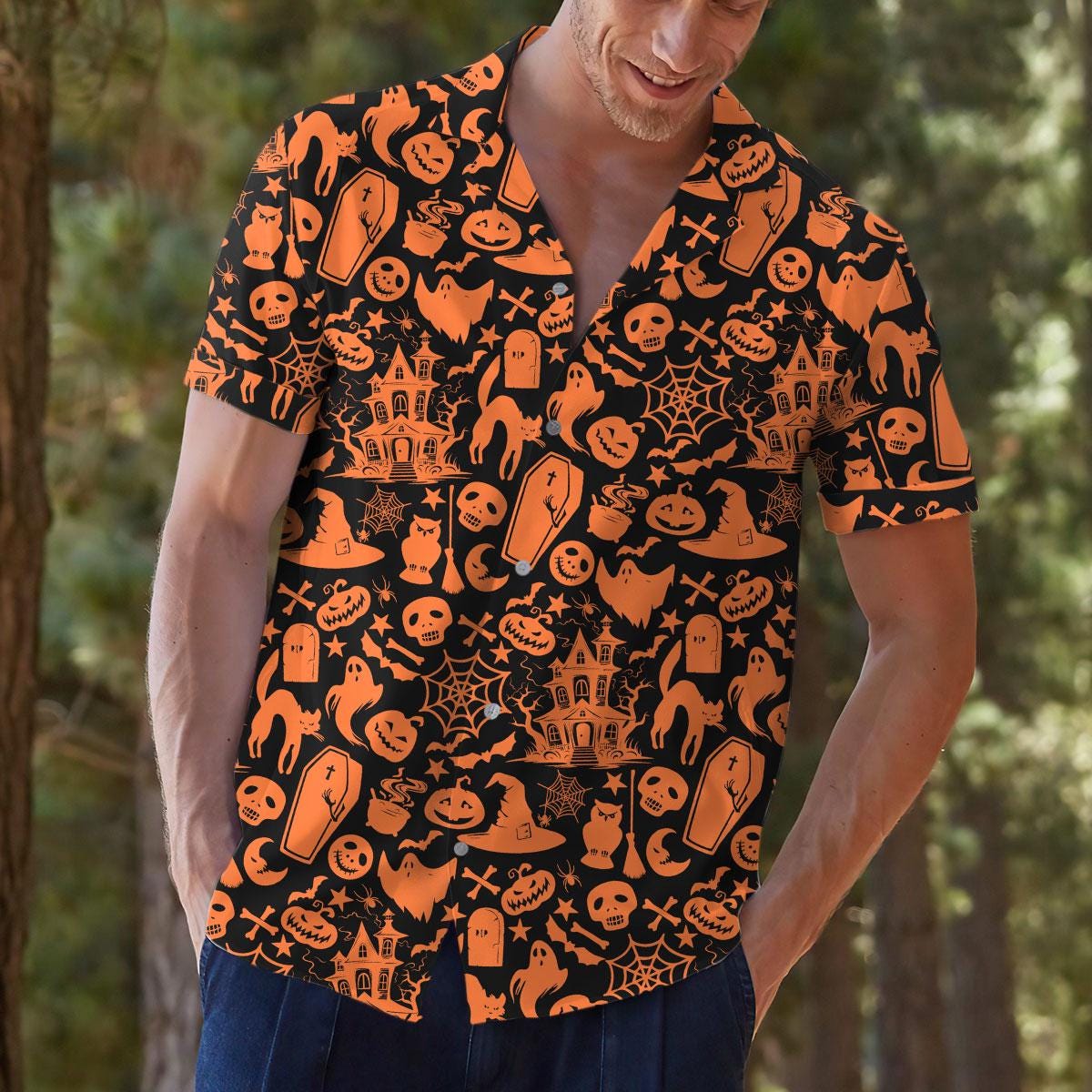 Model wearing Halloween Hawaiian shirt with pumpkins, ghosts, bats, and haunted house print