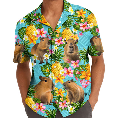 Model wearing the front of a colorful capybara and pineapple Hawaiian shirt