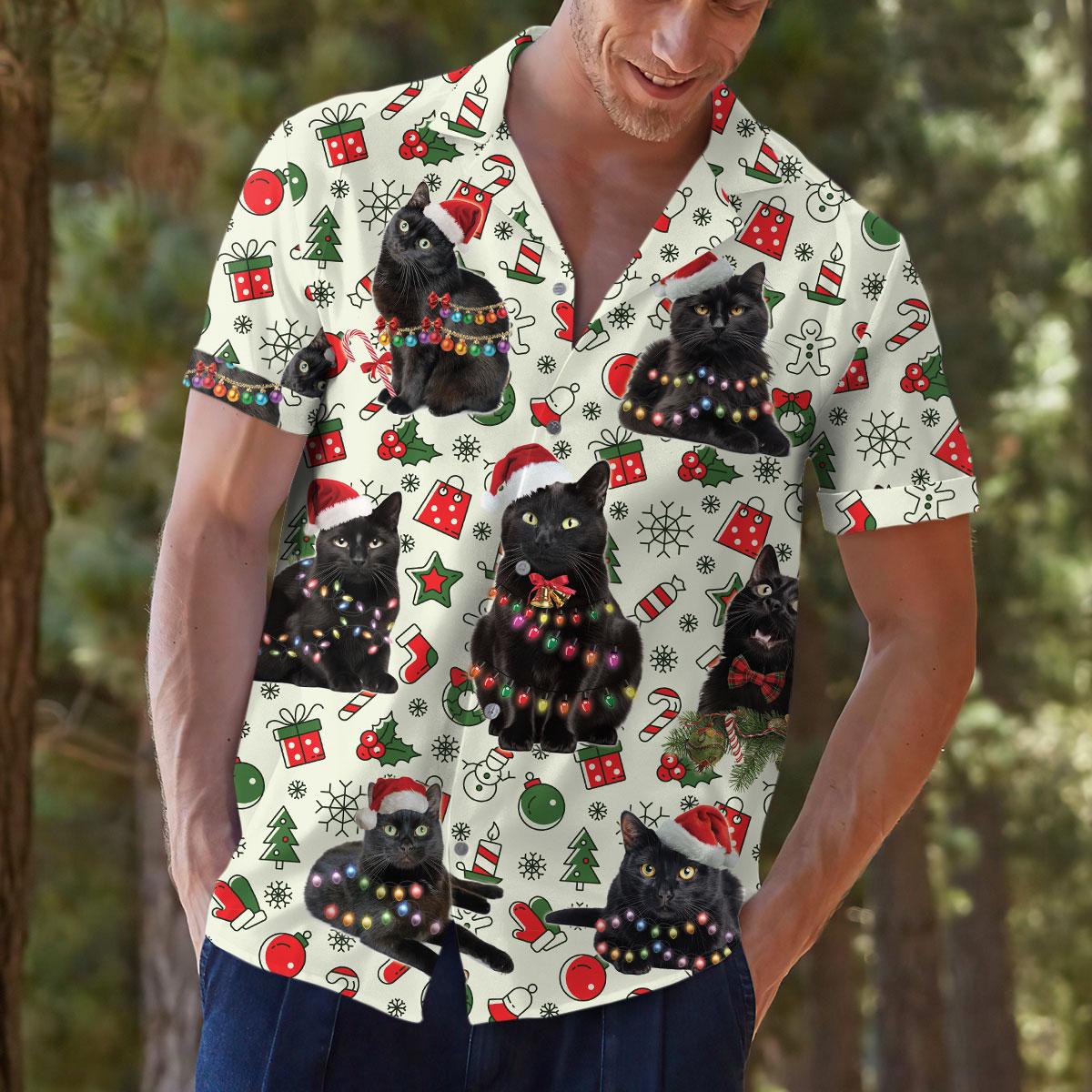Person modeling the festive black cat Hawaiian shirt outdoors with the seasonal print clearly visible.