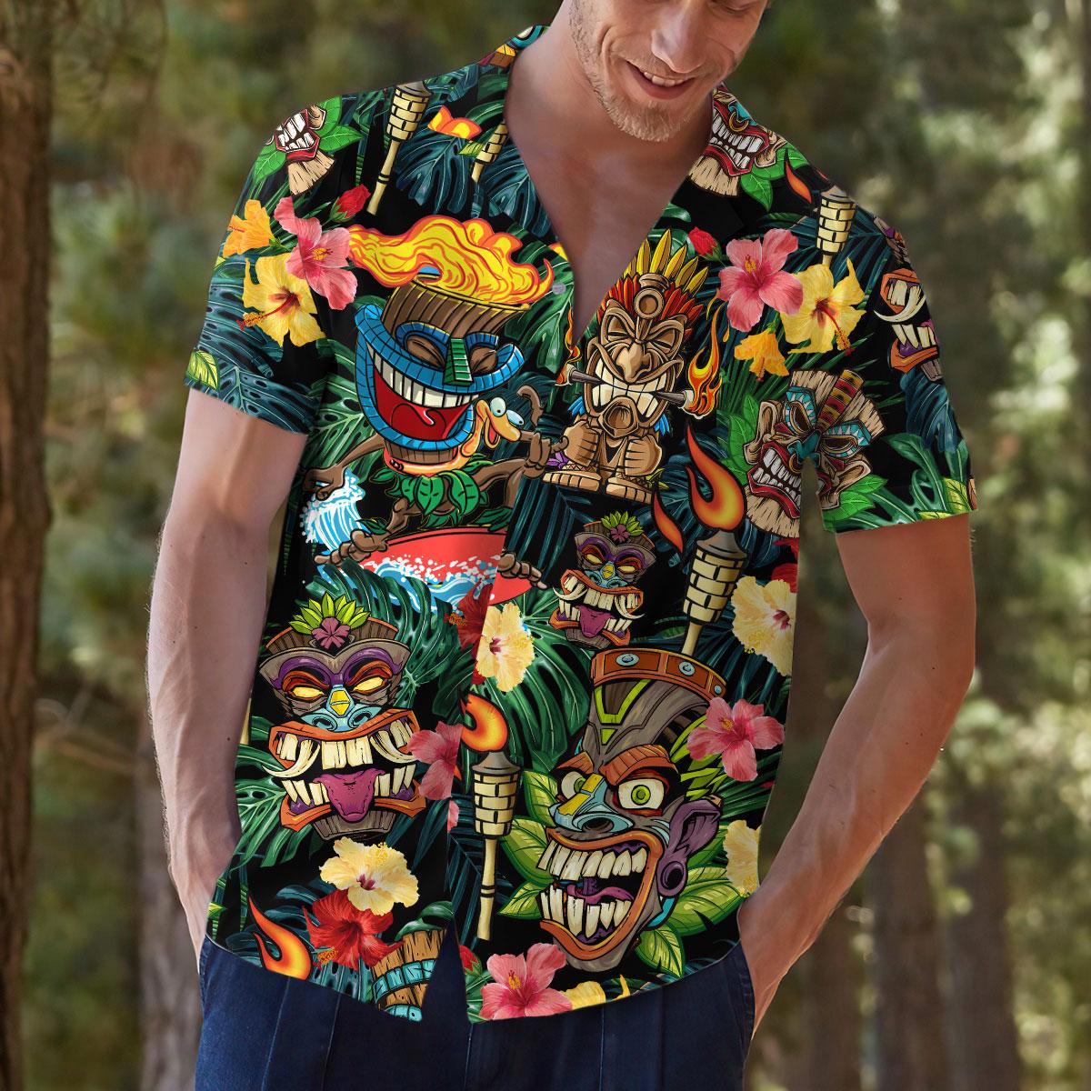 Model wearing tropical tiki Hawaiian shirt in a casual outdoor setting