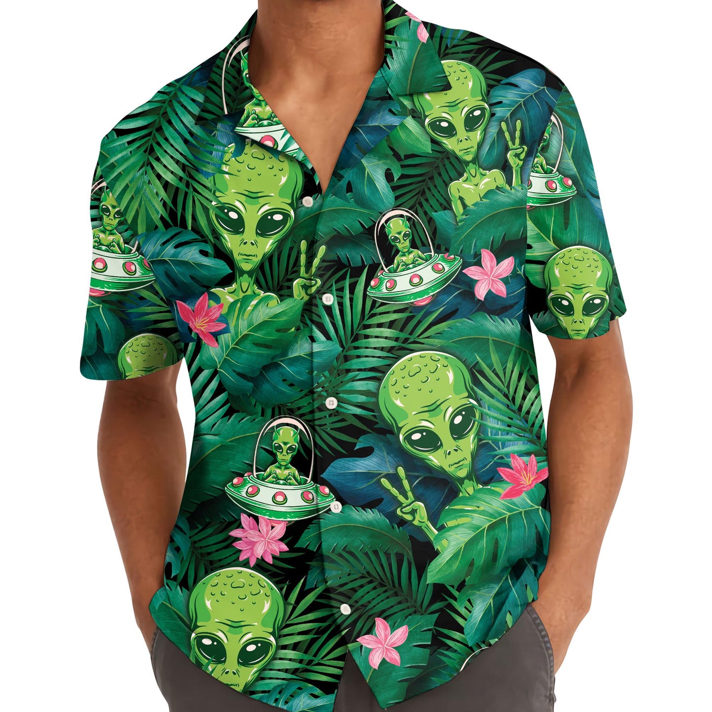 Person wearing a green alien UFO Hawaiian shirt with tropical foliage print