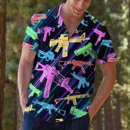 Person modeling the dark graphic Hawaiian shirt with bright multicolor gun illustrations