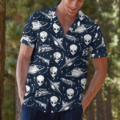Model outdoors wearing a navy space print Hawaiian shirt with alien and UFO artwork