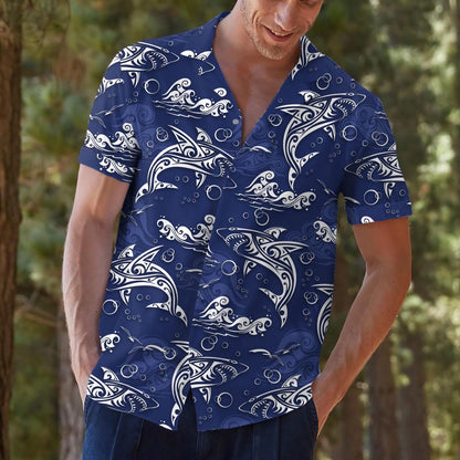 Model wearing blue ocean print Hawaiian shirt with hands in pockets