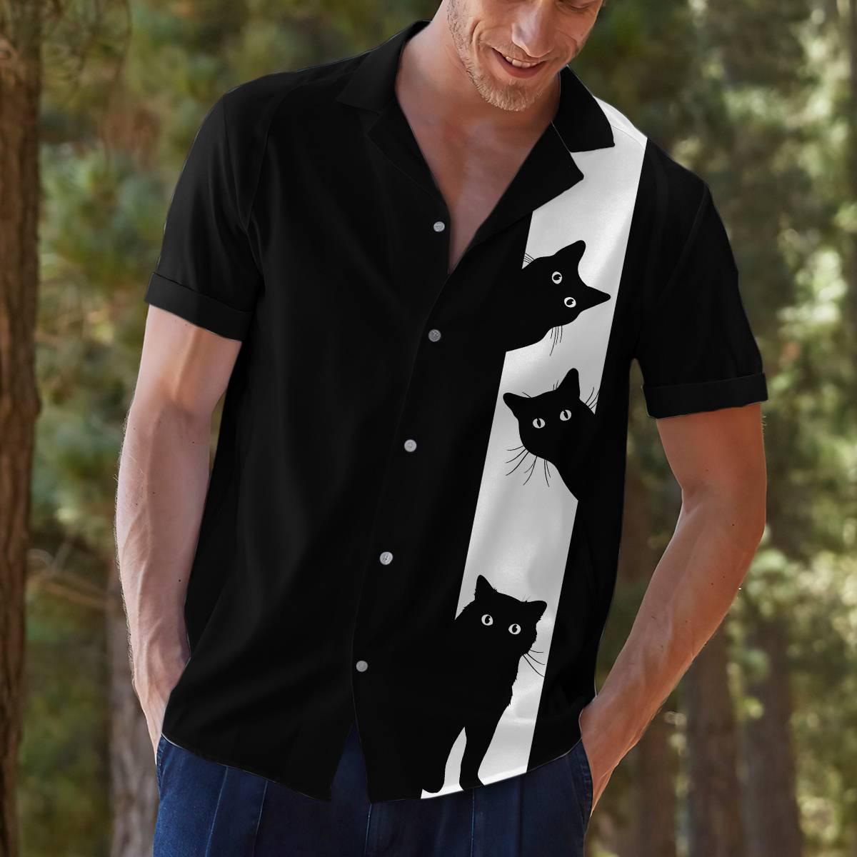 Model wearing a black Hawaiian shirt with three cats on a white stripe