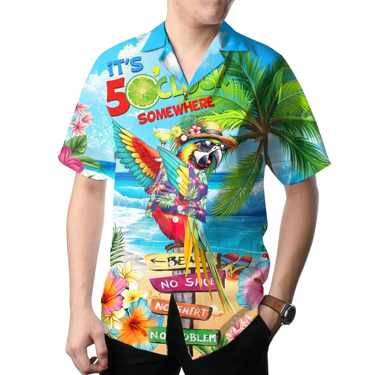 Model wearing colorful parrot Hawaiian shirt with tropical beach print