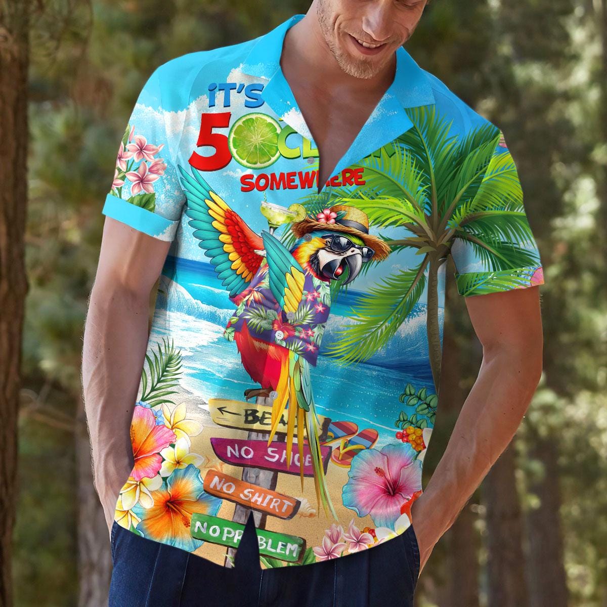 Model outdoors wearing bright tropical Hawaiian shirt with parrot artwork