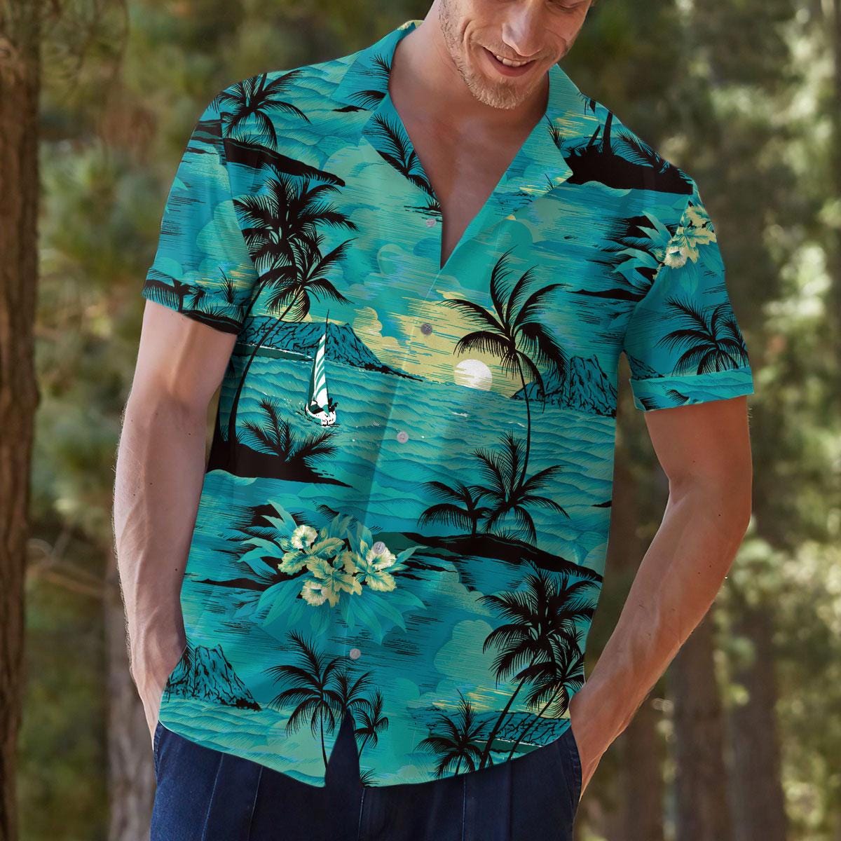 Model wearing a turquoise tropical shirt outdoors in a scenic casual setting