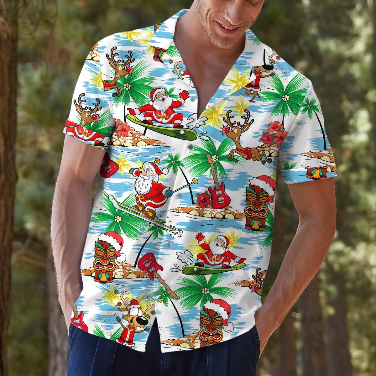 Close view of model wearing Santa and tiki tropical holiday shirt