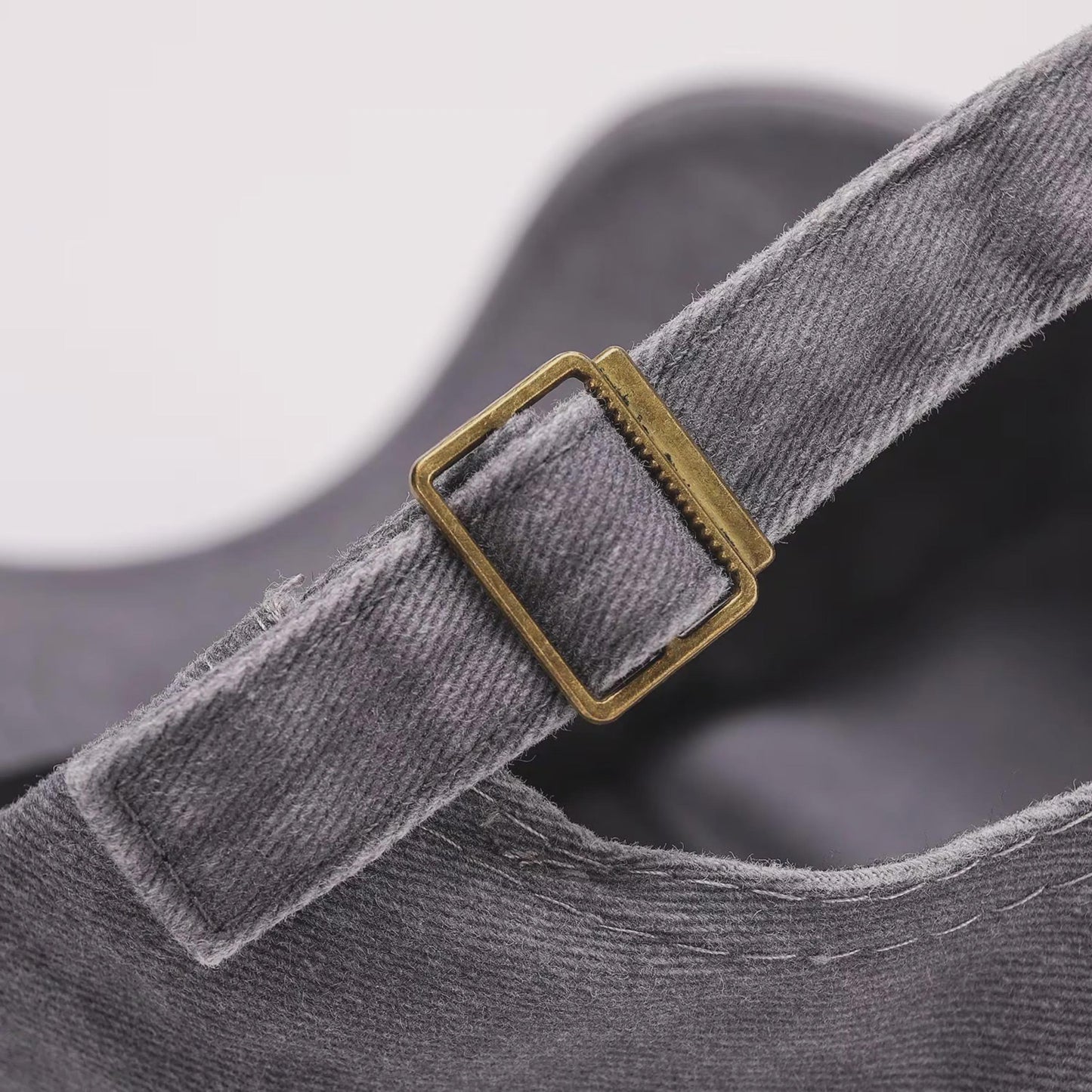 Close-up of the adjustable back strap and metal buckle on the hat