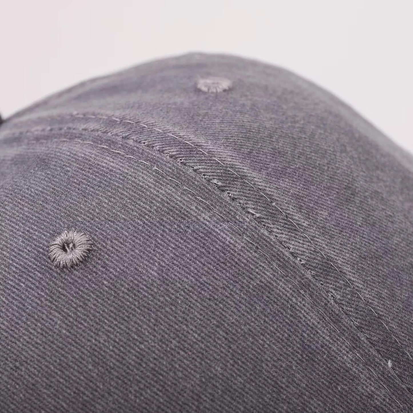 Close-up of the textured twill fabric and stitched panel on the cap